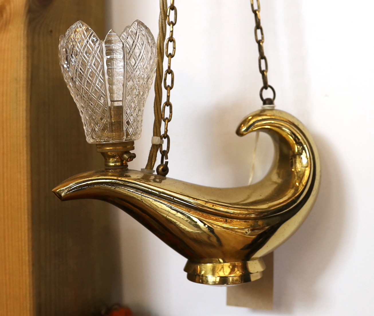 A 1930s English brass genie lamp with Osler cut glass shade and wall bracket, drop 53cm